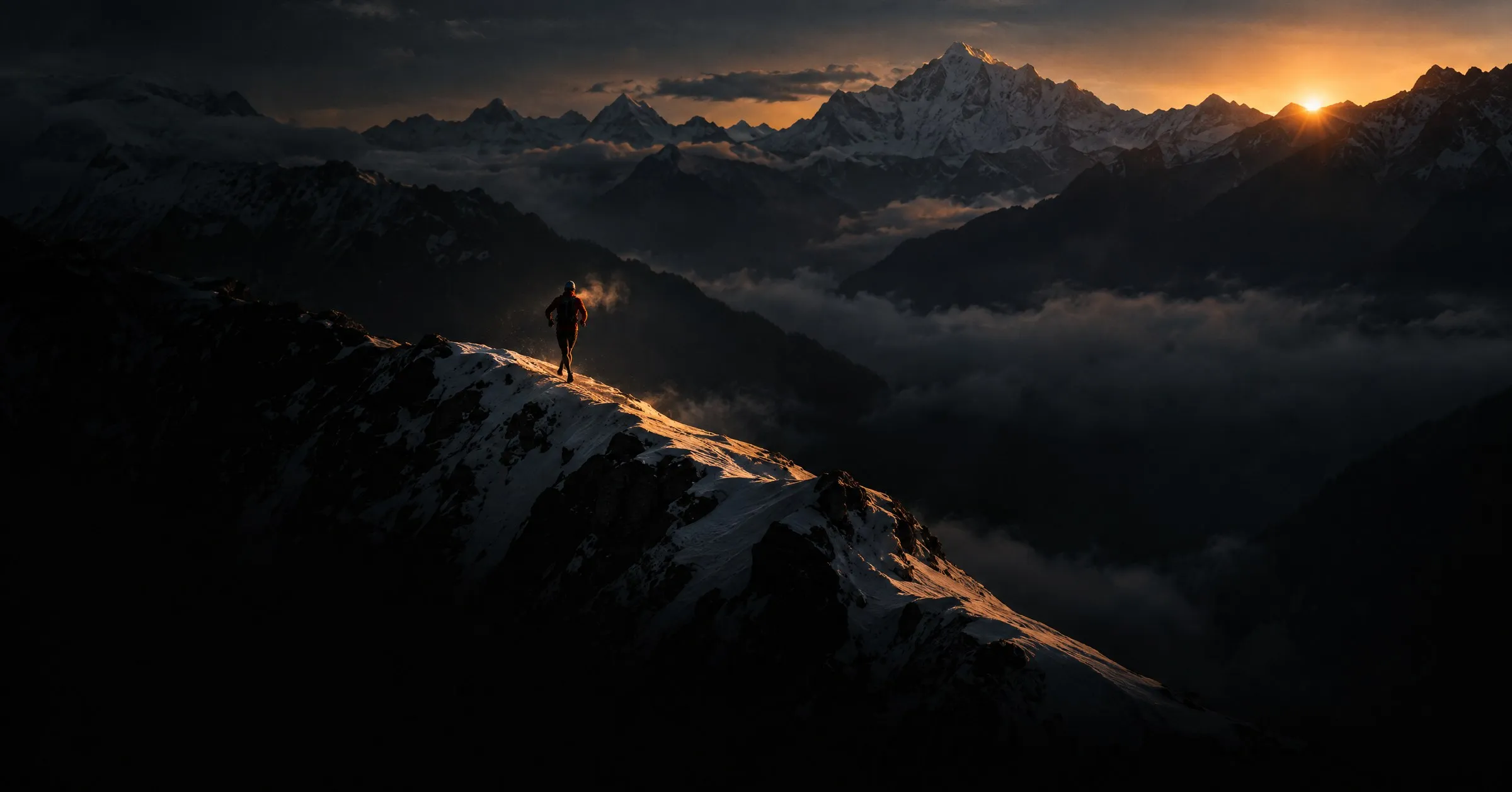 A trail runner on a snowy Himalayan ridge at sunrise